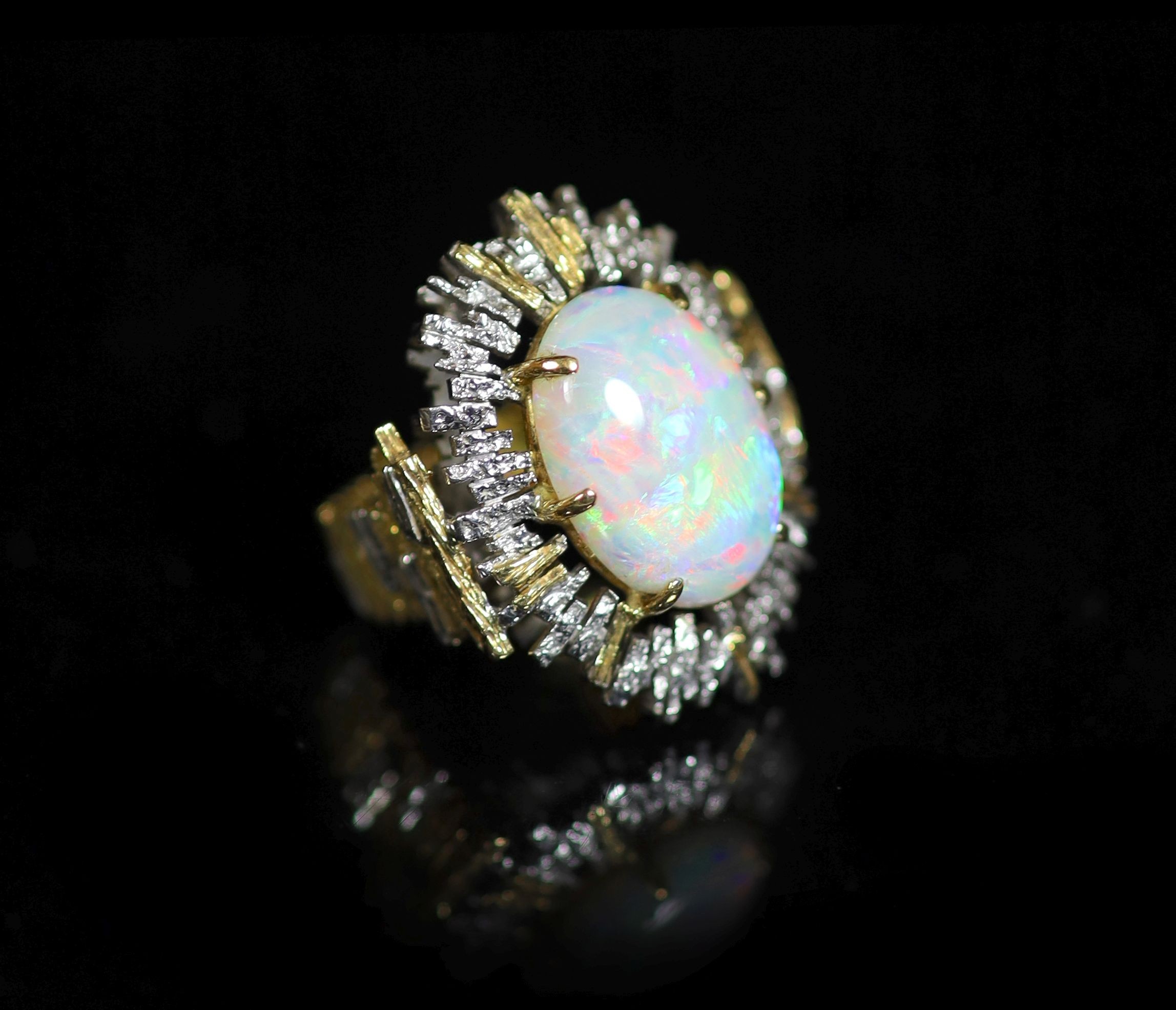 A 1970's? textured two colour 18ct gold and white opal set oval dress ring